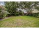 Serene backyard featuring a brick pathway, manicured landscaping, and mature trees, creating a peaceful ambiance at 1589 Royal Forest Ct, Lakeland, FL 33811