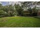 Well-maintained backyard featuring a green lawn, mature trees, and thoughtfully landscaped areas, creating a tranquil setting at 1589 Royal Forest Ct, Lakeland, FL 33811