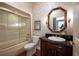 Elegant bathroom featuring a wooden vanity, granite countertop, and decorative floral wallpaper at 1589 Royal Forest Ct, Lakeland, FL 33811