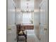 View through a doorway to a luxury bathroom with a soaking tub, plantation shutters, and a chandelier at 1589 Royal Forest Ct, Lakeland, FL 33811