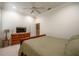 The bedroom features a fan, neutral walls, and dark wood furniture, plus an attached bathroom visible through doorway at 1589 Royal Forest Ct, Lakeland, FL 33811
