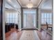 Elegant foyer featuring hardwood floors, decorative chandelier, and sidelights illuminating the front door at 1589 Royal Forest Ct, Lakeland, FL 33811
