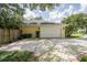 Spacious two-car garage featuring an expansive driveway and mature trees providing ample shade at 1589 Royal Forest Ct, Lakeland, FL 33811