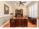 The home office features hardwood floors, a dark wood desk and cabinetry, and window with plantation shutters at 1589 Royal Forest Ct, Lakeland, FL 33811