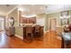 Open kitchen featuring granite counters, a breakfast bar, and hardwood flooring at 1589 Royal Forest Ct, Lakeland, FL 33811