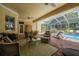 Beautiful covered lanai featuring a pool view and comfortable outdoor seating and furnishings at 1589 Royal Forest Ct, Lakeland, FL 33811