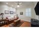 Cozy living room with leather sofa, area rug, and natural light from the shuttered window at 1589 Royal Forest Ct, Lakeland, FL 33811