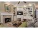 Cozy living room featuring built-in shelving, a fireplace, and comfortable seating, perfect for relaxation at 1589 Royal Forest Ct, Lakeland, FL 33811
