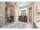 A spacious bathroom with a chandelier, dual vanities, a walk-in shower, and decorative wallpaper at 1589 Royal Forest Ct, Lakeland, FL 33811