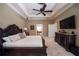 Spacious main bedroom with plush carpet, tray ceiling, a large dresser, and neutral wall-tones at 1589 Royal Forest Ct, Lakeland, FL 33811