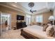 A bright main bedroom is spacious, with neutral decor, a ceiling fan, and french doors to the exterior at 1589 Royal Forest Ct, Lakeland, FL 33811