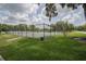 Community tennis court surrounded by lush green grass at 1589 Royal Forest Ct, Lakeland, FL 33811