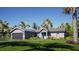 Charming single-story home with lush landscaping, solar panels, and a two-car garage at 161 Pecan Dr, Ocala, FL 34472