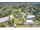 Aerial view shows the home within a neighborhood, highlighting the yard, sheds, and surrounding greenery at 1685 Kissengen Ave, Bartow, FL 33830