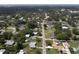 Overhead view of a residential street with a mix of homes, lush greenery, and a glimpse of a nearby lake at 1685 Kissengen Ave, Bartow, FL 33830