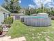Backyard featuring an above-ground pool, storage, and lush greenery for outdoor enjoyment at 1685 Kissengen Ave, Bartow, FL 33830
