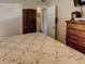 Comfortable bedroom with a wooden dresser, closet, and views of the hallway at 1685 Kissengen Ave, Bartow, FL 33830