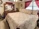 Spacious bedroom with a dresser, large bed with floral patterns, and great natural light at 1685 Kissengen Ave, Bartow, FL 33830
