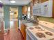 Functional kitchen with wood cabinets, white appliances, and view to living room at 1685 Kissengen Ave, Bartow, FL 33830