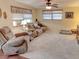 Cozy living room with comfortable seating, plush carpet, and great natural light at 1685 Kissengen Ave, Bartow, FL 33830