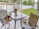 Enclosed patio features seating, a table with views of the fenced yard, a storage shed, and greenery at 1685 Kissengen Ave, Bartow, FL 33830