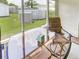 Enclosed patio shows glass table with a chair offering backyard views including an above ground pool at 1685 Kissengen Ave, Bartow, FL 33830