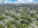 An aerial view showcases the neighborhood, nearby houses and green trees at 1715 Lando Ln, Orlando, FL 32806