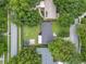 An aerial view showing the home's location, with nearby roads, a large yard, and mature trees at 1715 Lando Ln, Orlando, FL 32806