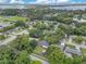 An aerial view features the property in a lush, tree-lined neighborhood, showcasing its location and expansive backyard at 1715 Lando Ln, Orlando, FL 32806