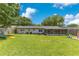 This home features a expansive backyard with a screened porch and patio, great for outdoor living at 1715 Lando Ln, Orlando, FL 32806