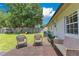 A spacious backyard with a patio, mature shade tree, a playset, and green grass at 1715 Lando Ln, Orlando, FL 32806