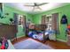 Bright bedroom with bunk beds, light green walls, wood floors, and lots of natural light at 1715 Lando Ln, Orlando, FL 32806