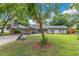 Inviting single-story home featuring a well-kept lawn, carport, and a basketball hoop at 1715 Lando Ln, Orlando, FL 32806