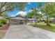 Charming home featuring a covered carport with brick accents and a well-maintained driveway at 1715 Lando Ln, Orlando, FL 32806