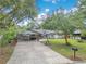 Lovely single-story house showcasing a carport with brick columns and a well-manicured front yard at 1715 Lando Ln, Orlando, FL 32806