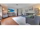 Inviting living room featuring a large TV, hardwood floors, and a stylish accent chair at 1715 Lando Ln, Orlando, FL 32806