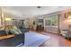 Cozy living room with hardwood floors, large windows, and comfortable seating area at 1715 Lando Ln, Orlando, FL 32806