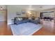 Comfortable living room featuring hardwood floors, a plush sectional sofa, and access to dining area at 1715 Lando Ln, Orlando, FL 32806