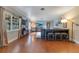 Bright living room with wood-look floors, large windows, and a modern dining table with counter stools at 1715 Lando Ln, Orlando, FL 32806