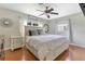 Bright main bedroom features a ceiling fan, wood floors, and light-colored walls and trim at 1715 Lando Ln, Orlando, FL 32806
