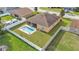 Spacious backyard with a sparkling in-ground pool, screened-in patio, and white fence, ideal for outdoor enjoyment at 1975 Country Manor St, Bartow, FL 33830