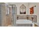 Well-appointed bathroom with a soaking tub, walk-in shower, and decorative details for a spa-like experience at 1975 Country Manor St, Bartow, FL 33830