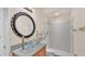 Bright bathroom featuring a modern glass bowl sink, a decorative mirror, and tiled walk-in shower at 1975 Country Manor St, Bartow, FL 33830