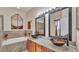Elegant bathroom featuring dual vessel sinks, a soaking tub, and decorative accents for a luxurious feel at 1975 Country Manor St, Bartow, FL 33830