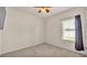 Spare bedroom featuring a window with blinds, a ceiling fan, and neutral colored carpet at 1975 Country Manor St, Bartow, FL 33830