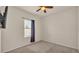 Simple bedroom featuring neutral walls, a window with blinds, carpet, and ceiling fan at 1975 Country Manor St, Bartow, FL 33830