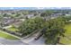 Neighborhood entrance featuring decorative stone pillars, mature trees, and lush landscaping in a quiet community at 1975 Country Manor St, Bartow, FL 33830