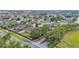 Neighborhood entrance featuring decorative stone pillars, mature trees, and lush landscaping in a quiet community at 1975 Country Manor St, Bartow, FL 33830