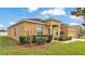 Charming single-story home with a well-manicured lawn and a two-car garage on a sunny day at 1975 Country Manor St, Bartow, FL 33830