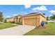 Charming single-story home with a well-manicured lawn and a two-car garage on a sunny day at 1975 Country Manor St, Bartow, FL 33830